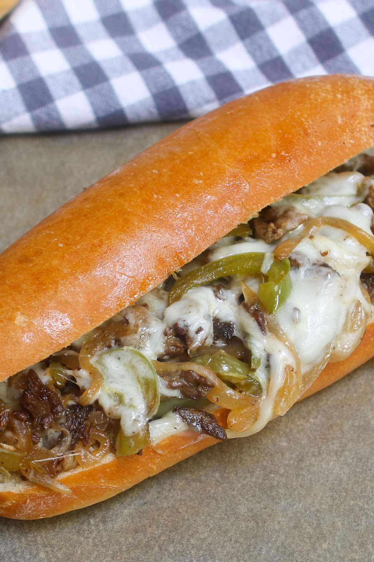 Philly Cheesesteak Recipe is a classic combination of thinly sliced steak and melted cheese in a soft and crusty roll. This philly steak sandwich is easy to make at home and rivals the best philly cheesesteaks in Philadelphia!