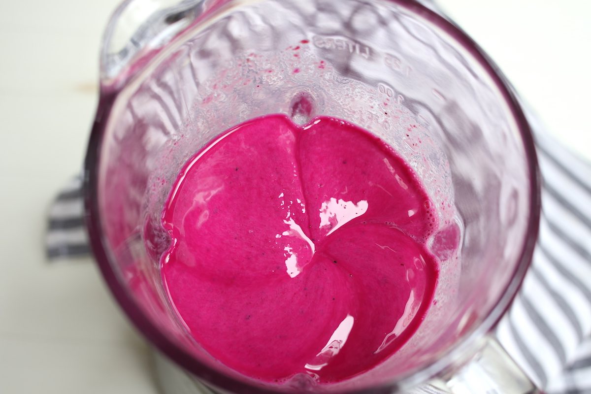 View of the bright magenta smoothie inside the blender after pureeing