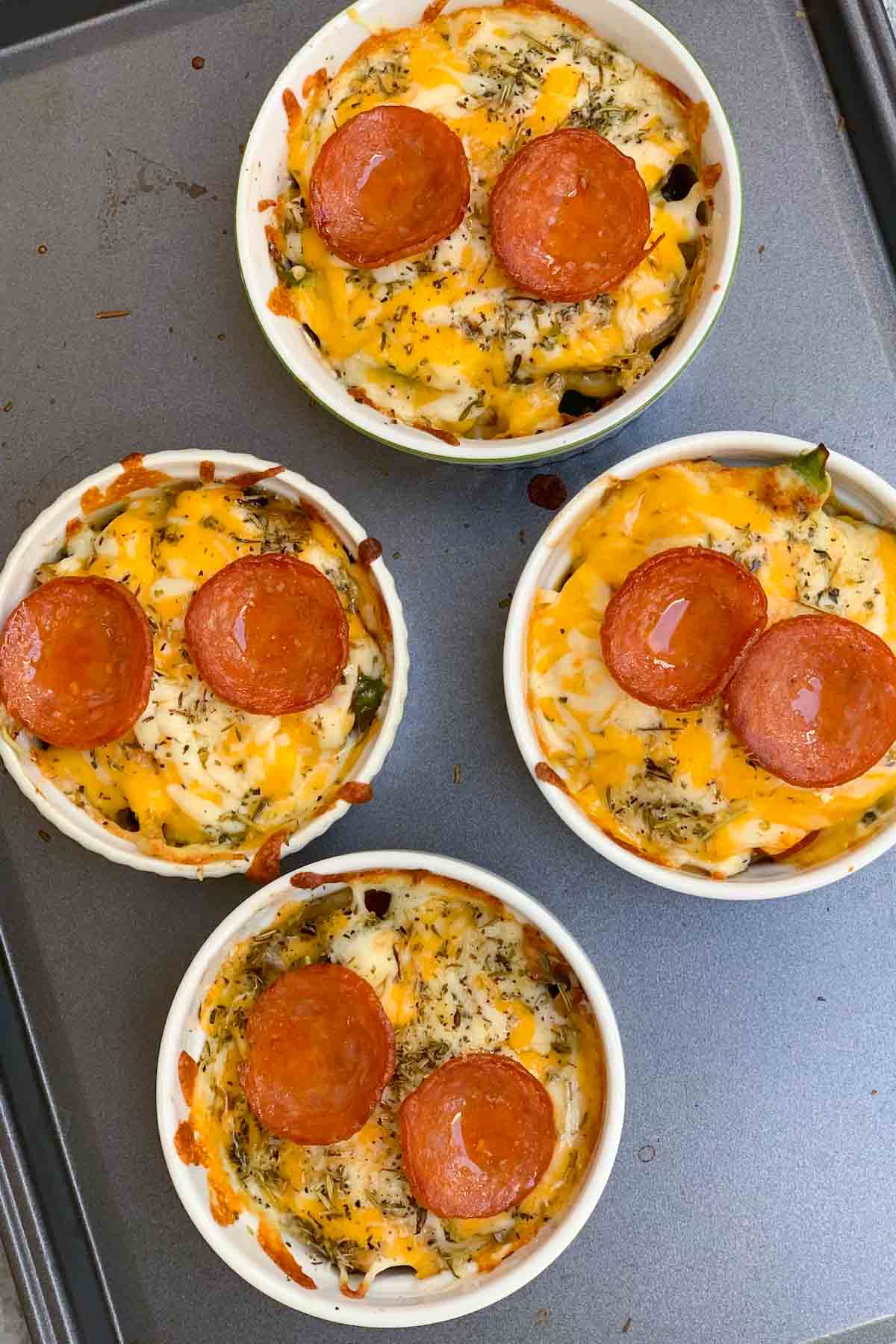 These Easy Pizza Bowls are freshly baked crustless pizza with your favorite toppings like pepperoni, veggies, and cheese! It takes less than 15 minutes to make and this low-carb option will satisfy your pizza cravings without blowing your Macro’s.