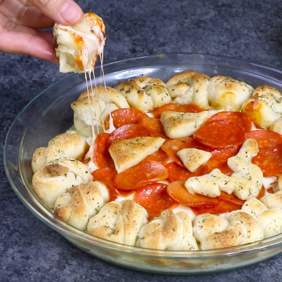 An epic cheese pull on a Halloween pizza dip