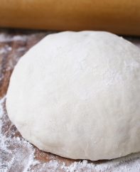 This Easy Pizza Dough Recipe makes a soft and fluffy pizza crust that’s beyond addictive! It’s the best homemade pizza dough that has been passed down through generations. It takes 10 minutes to prepare and made by hand with 6 simple ingredients!