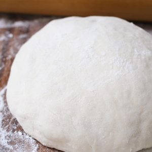This Easy Pizza Dough Recipe makes a soft and fluffy pizza crust that’s beyond addictive! It’s the best homemade pizza dough that has been passed down through generations. It takes 10 minutes to prepare and made by hand with 6 simple ingredients!