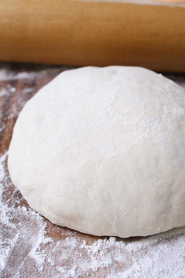 This Easy Pizza Dough Recipe makes a soft and fluffy pizza crust that’s beyond irresistible! It’s the best homemade pizza dough that has been passed down through generations. It takes 10 minutes to prepare and made by hand with 6 simple ingredients!
