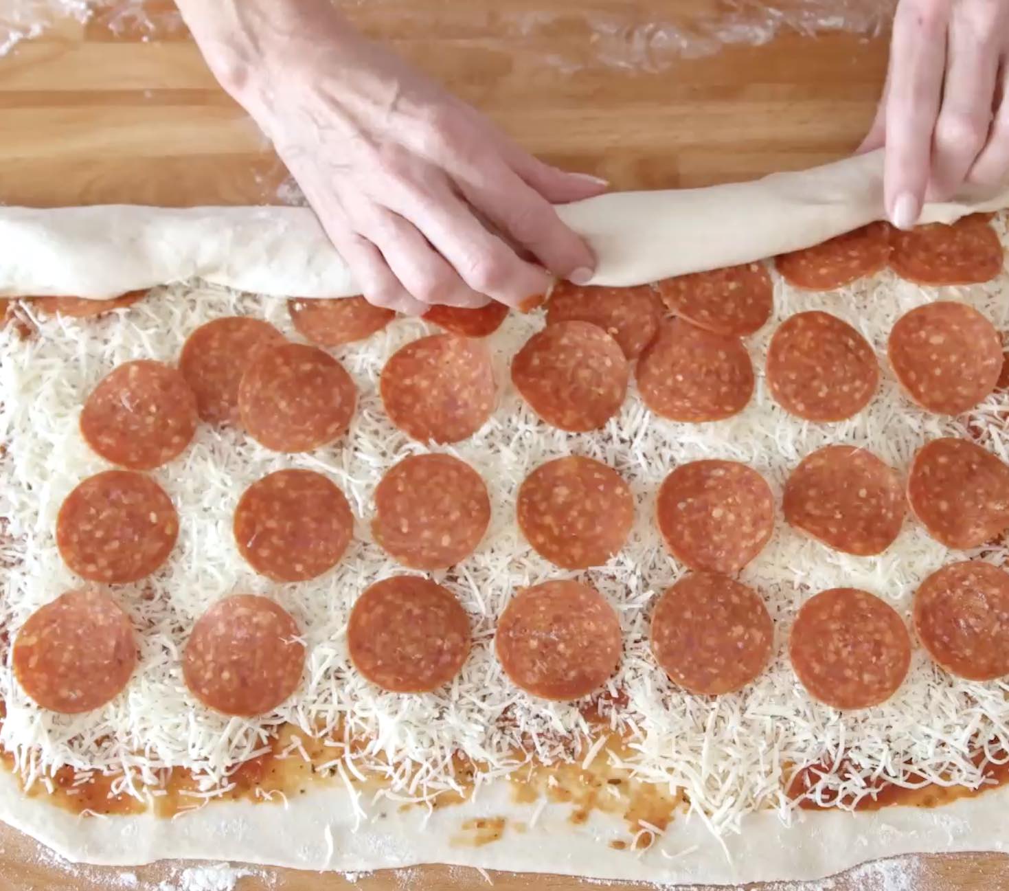 Pizza rolls are essentially pizza in rolled-up form like pinwheels. So everything goes into a pizza can be included in a pizza roll: pizza dough and pizza toppings such as tomato sauce, pepperoni and cheese. 