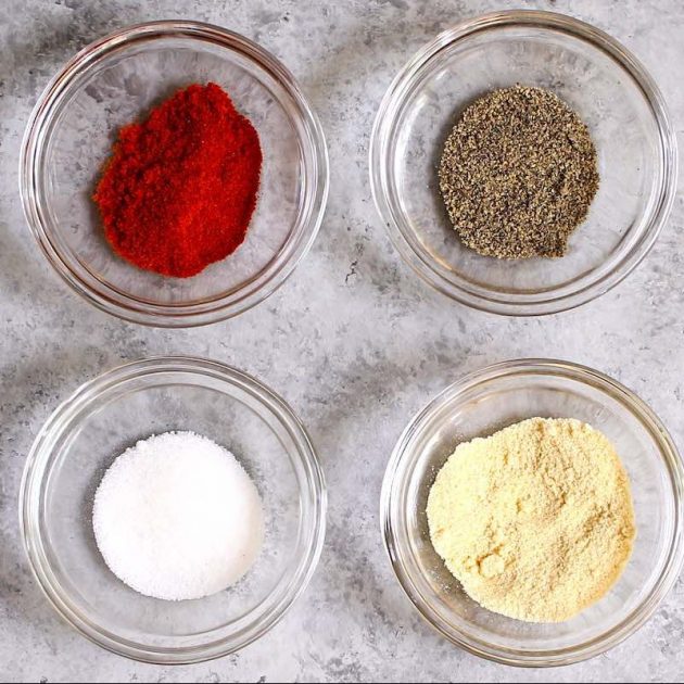 Paprika, garlic powder, salt and black pepper in small bowls