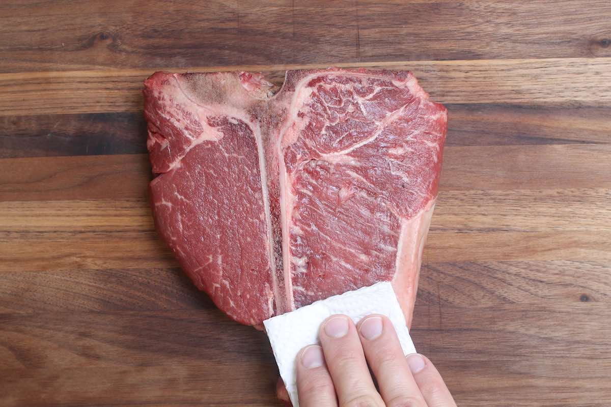 Pat dry the steak with paper towels.