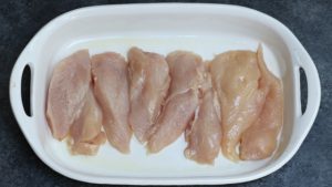 Chicken fillets in a greased baking dish