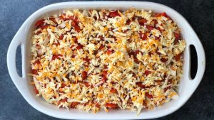 Chicken fajita casserole with cheese on top ready to go into the oven