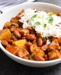 Puerto Rican Rice and Beans are thick, creamy and flavorful! The tender beans are simmered in a sofrito and tomato based sauce, then served over rice. It’s a Puerto Rican staple, also known as Habichuelas Guisadas or stewed beans.