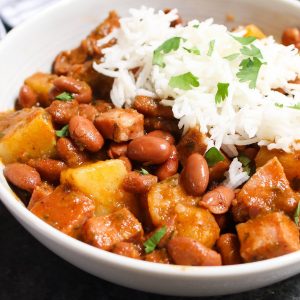Puerto Rican Rice and Beans are thick, creamy and flavorful! The tender beans are simmered in a sofrito and tomato based sauce, then served over rice. It’s a Puerto Rican staple, also known as Habichuelas Guisadas or stewed beans.