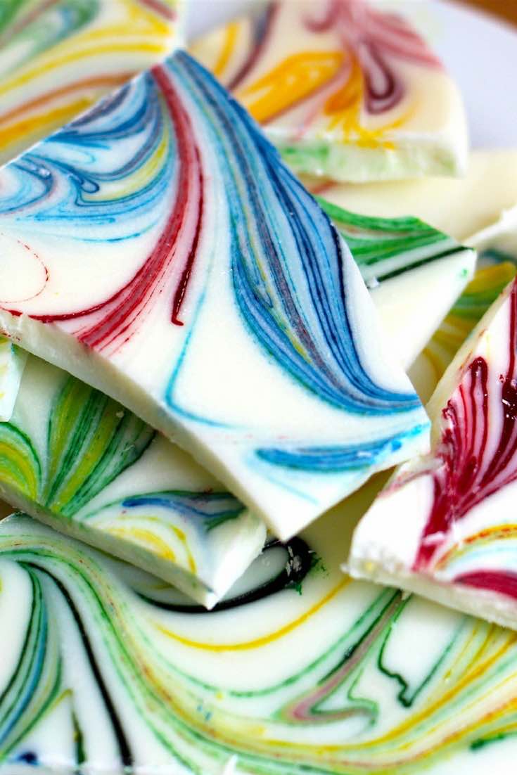 Pieces of marbled white chocolate bark on a serving plate