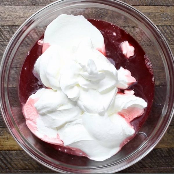 Raspberry Chocolate Mousse - this is a photo of making raspberry mousse by mixing together raspberry jello and whipped topping in a bowl