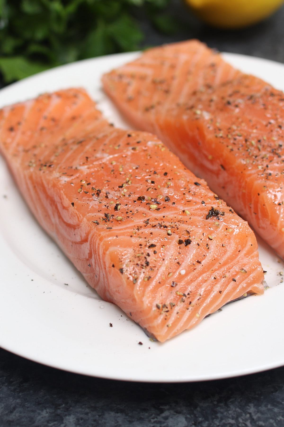 Dry seasoned salmon fillets ready for baking