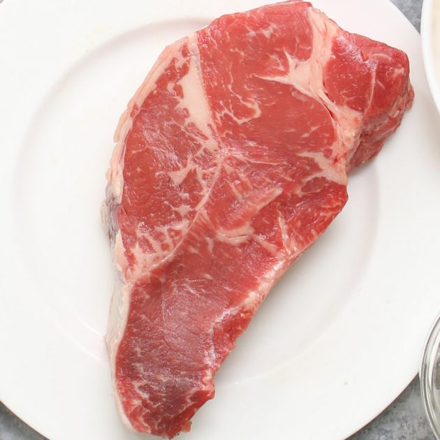 Raw Sirloin Steak on a white plate