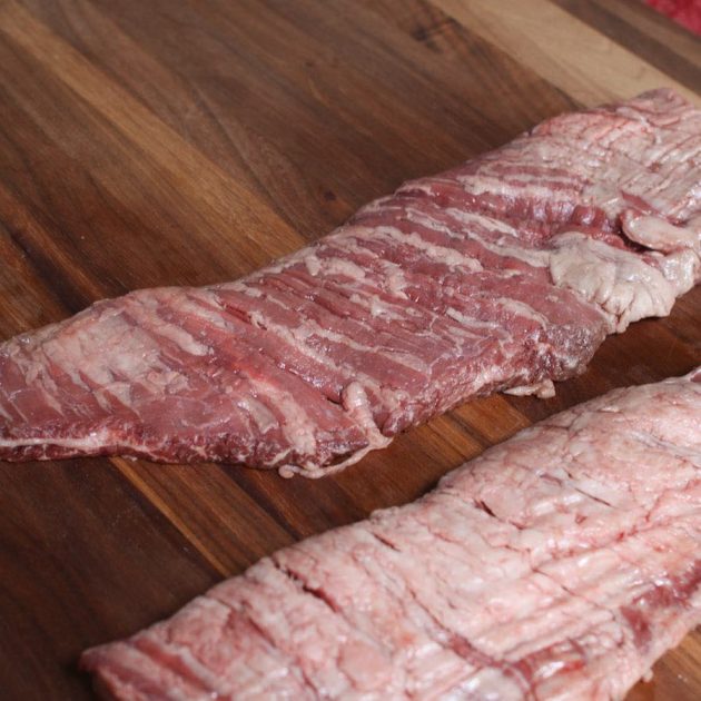 raw skirt steak on a cutting board