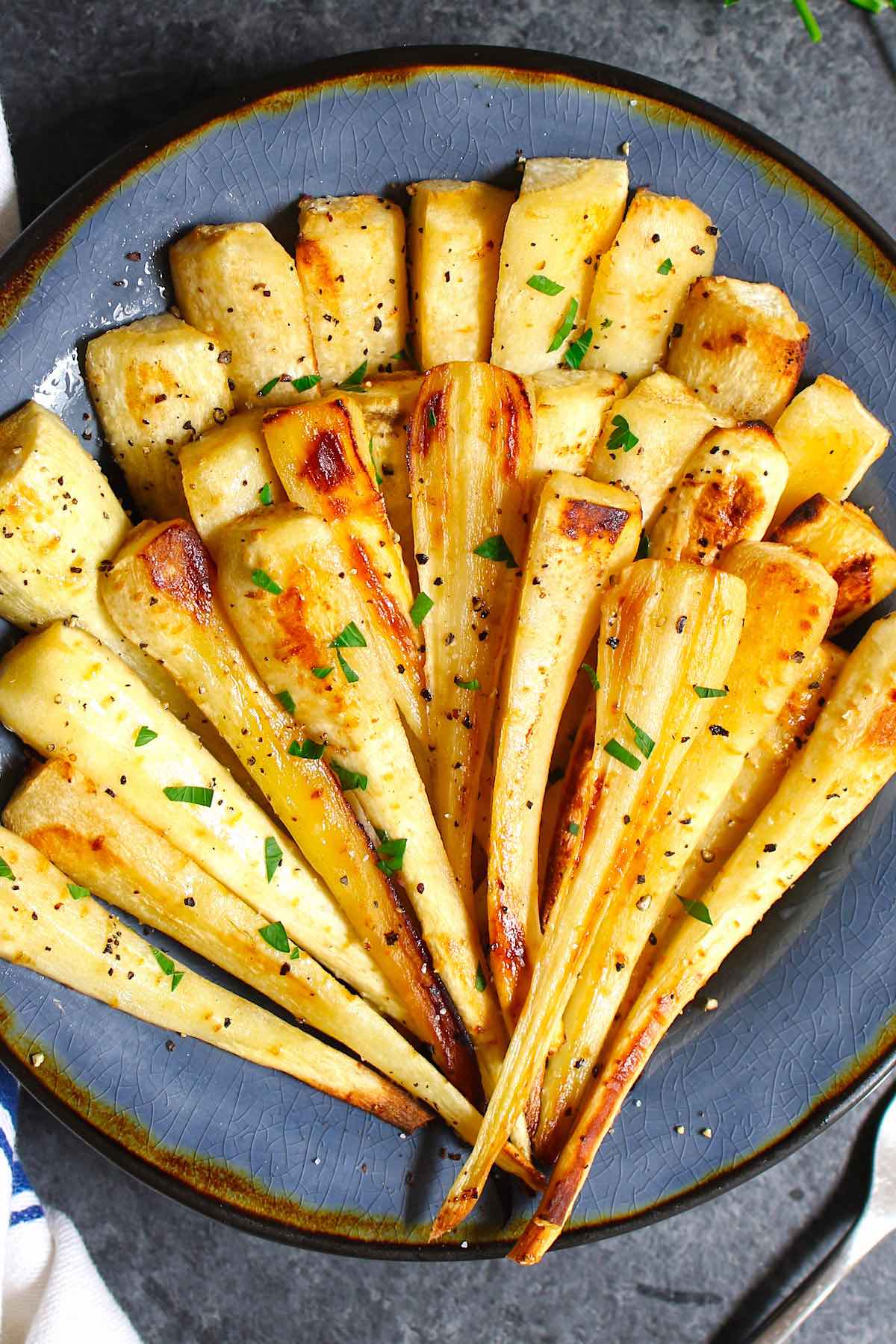 Roasted Parsnips are a very simple but delicious vegetable side dish that’s sweet and tender. This recipe makes perfect parsnips with a caramelized surface that enhances the natural flavor.