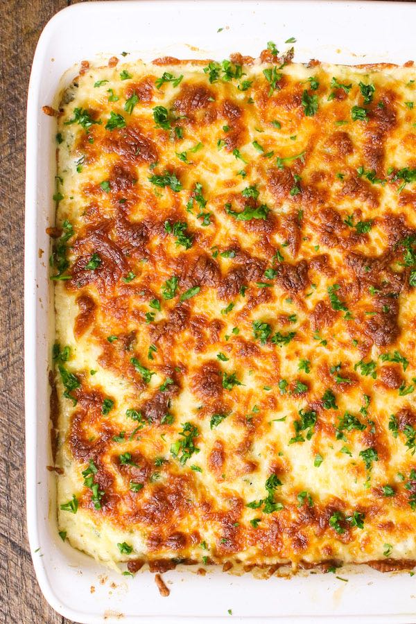 Easy Scalloped Potatoes with Ham baked golden and brown in a white baking dish