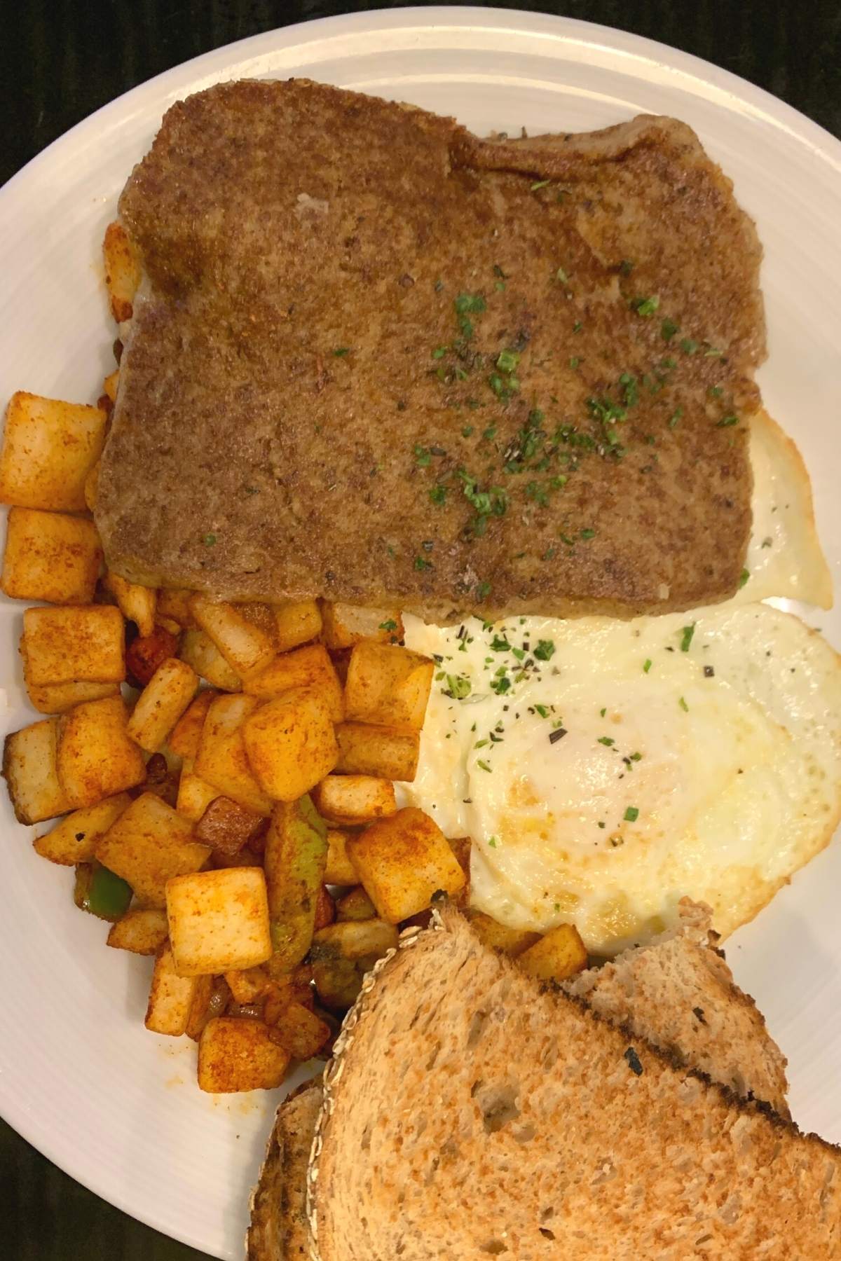 A slice of scrapple served for breakfast with eggs and toast