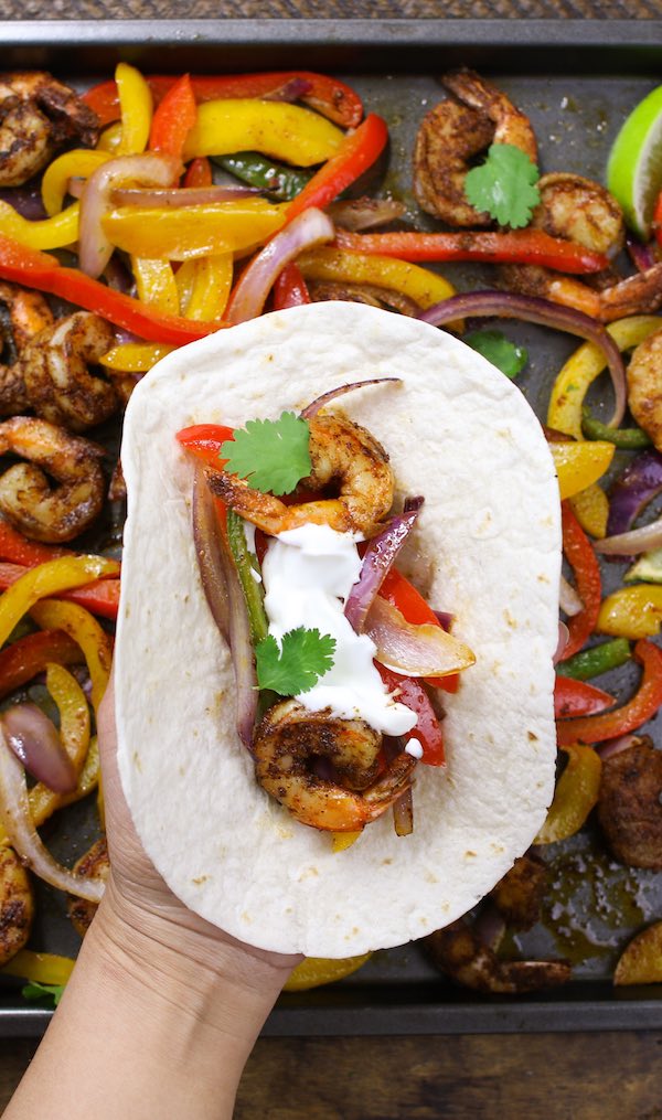 Assemble Fajitas with flour tortilla, sour cream and cilantro