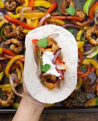 These Baked Shrimp Fajitas is an easy one pan meal with gorgeously browned and sizzling shrimp mixed with delicious vegetables cooked with fajita seasonings. It tastes amazing and takes only 20 minutes to make.