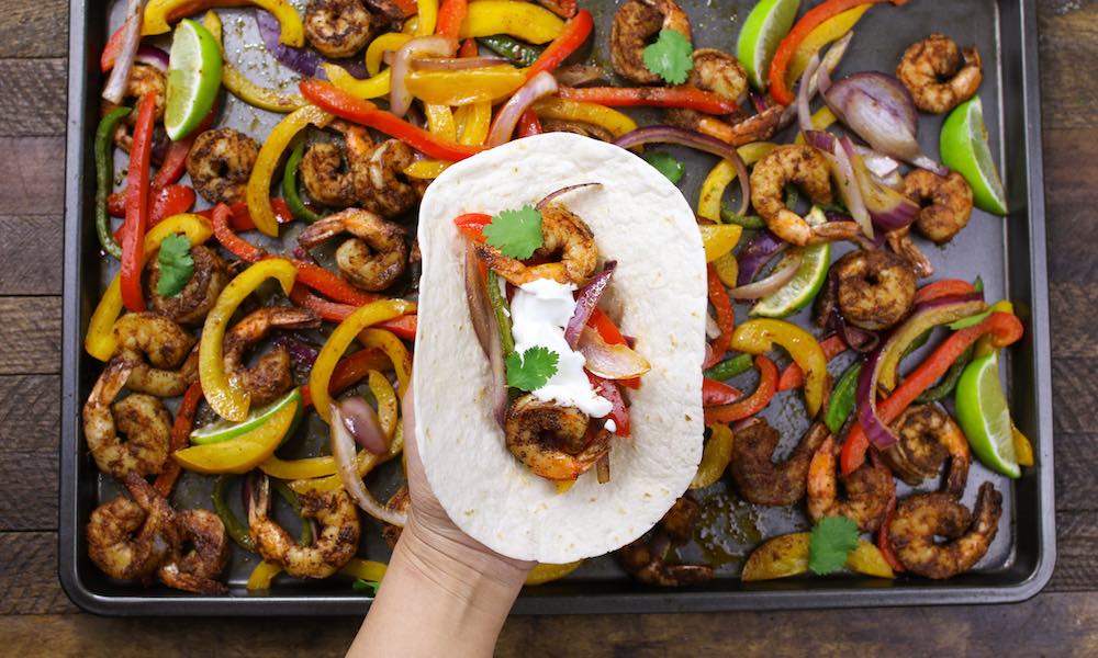 These Baked Shrimp Fajitas is an easy one pan meal with gorgeously browned and sizzling shrimp mixed with delicious vegetables cooked with fajita seasonings. It tastes amazing and takes only 20 minutes to make.