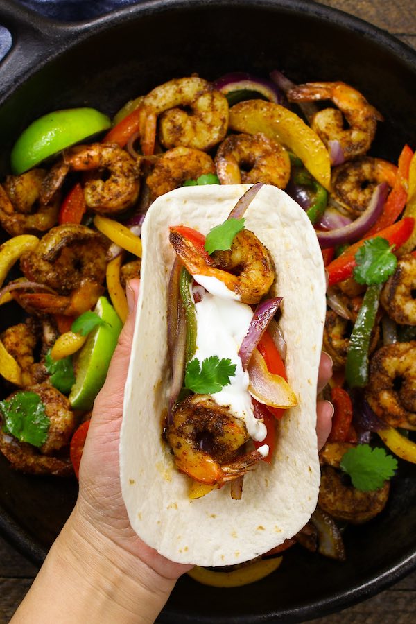 Shrimp Fajitas topped with sour cream, cilantro and served on tortilla