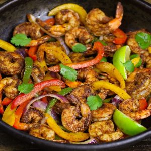 These Shrimp Fajitas are easy to make in just 15 minutes – sizzling, caramelized shrimp cooked with seared bell peppers and onions in flavorful fajita seasonings. It’s like restaurant-style fajitas but even better! #shrimpFajitas