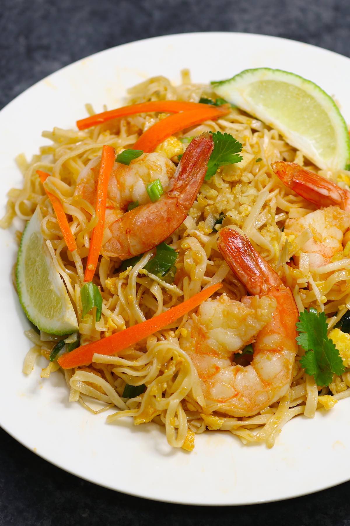 Shrimp Pad Thai is loaded with sweet, sour and spicy shrimp, mixed with rice noodles and vegetables. It’s so simple and easy to make. Try it once and you won’t want to go back to takeout! It comes together in only 20 minutes. 