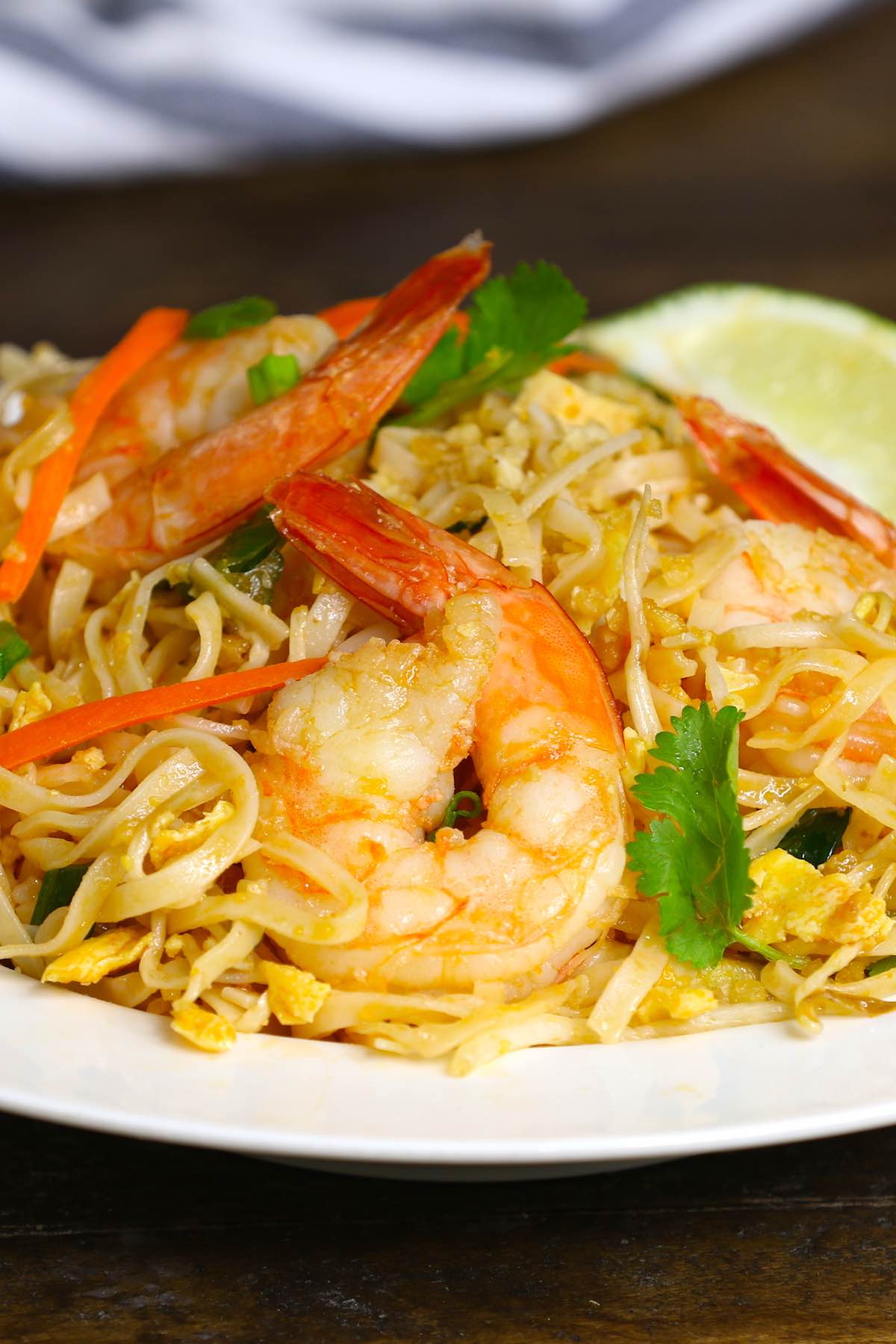 Shrimp Pad Thai is loaded with sweet, sour and spicy shrimp, mixed with rice noodles and vegetables. It’s so simple and easy to make. Try it once and you won’t want to go back to takeout! It comes together in only 20 minutes. 