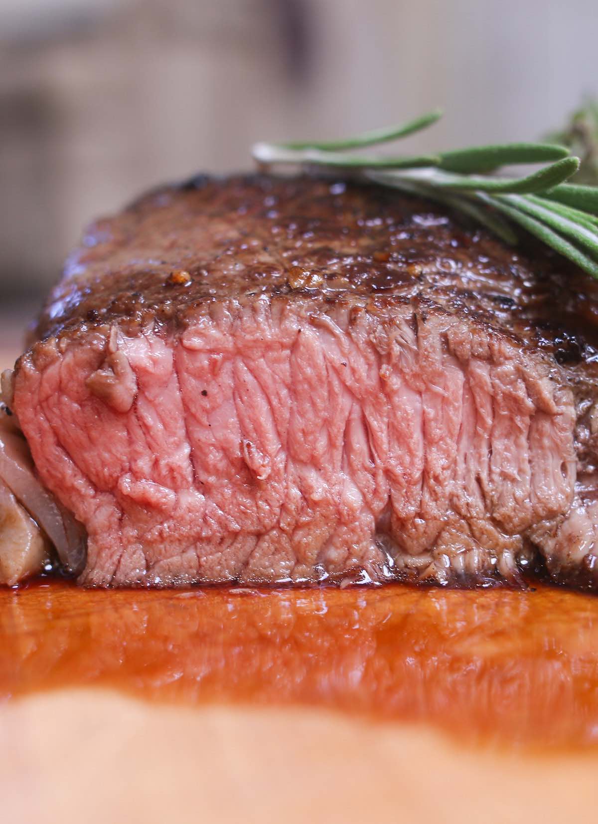 Cross-section view of beefsteak cooked medium with a warm pink center