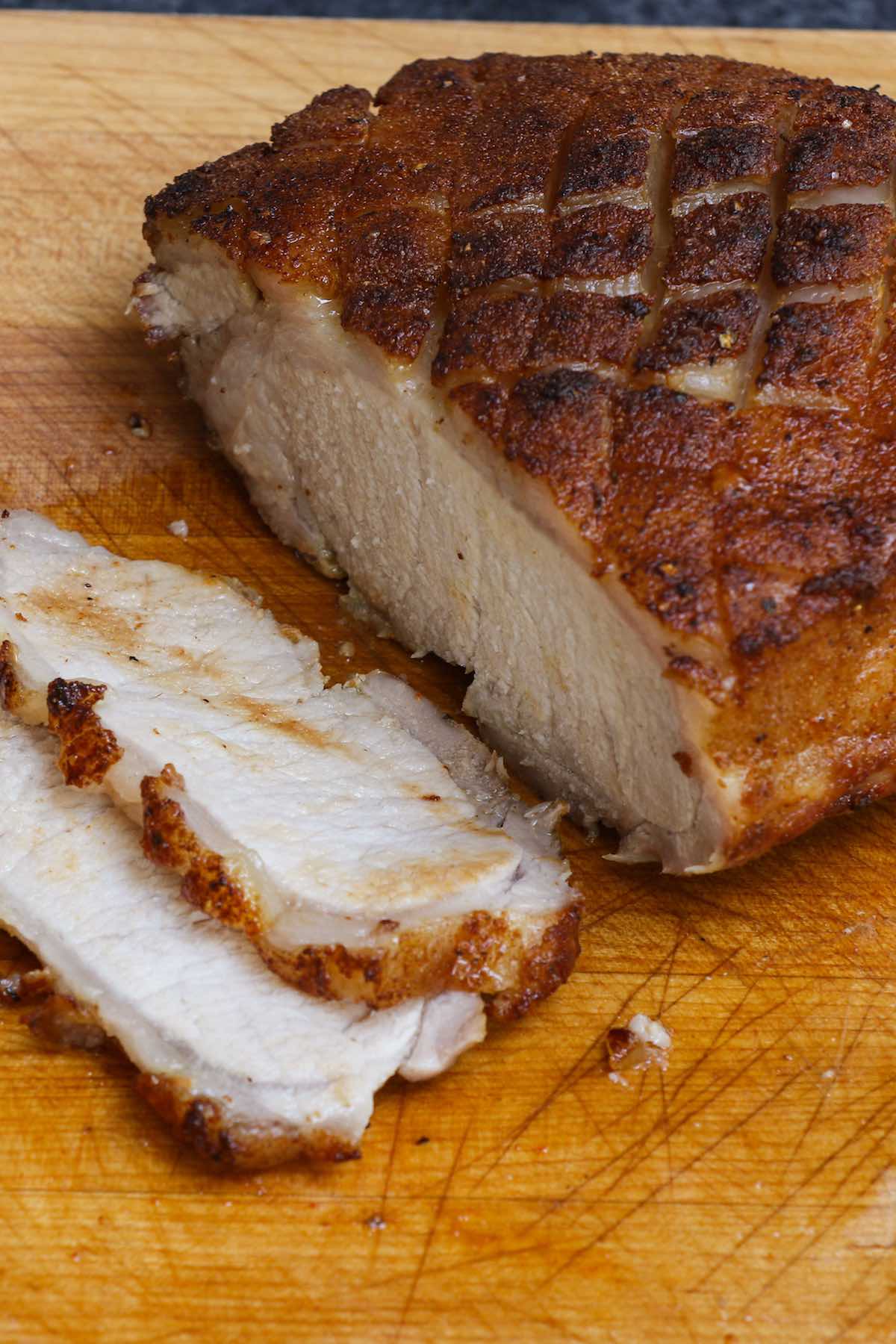 Juicy slices of pork on a carving board