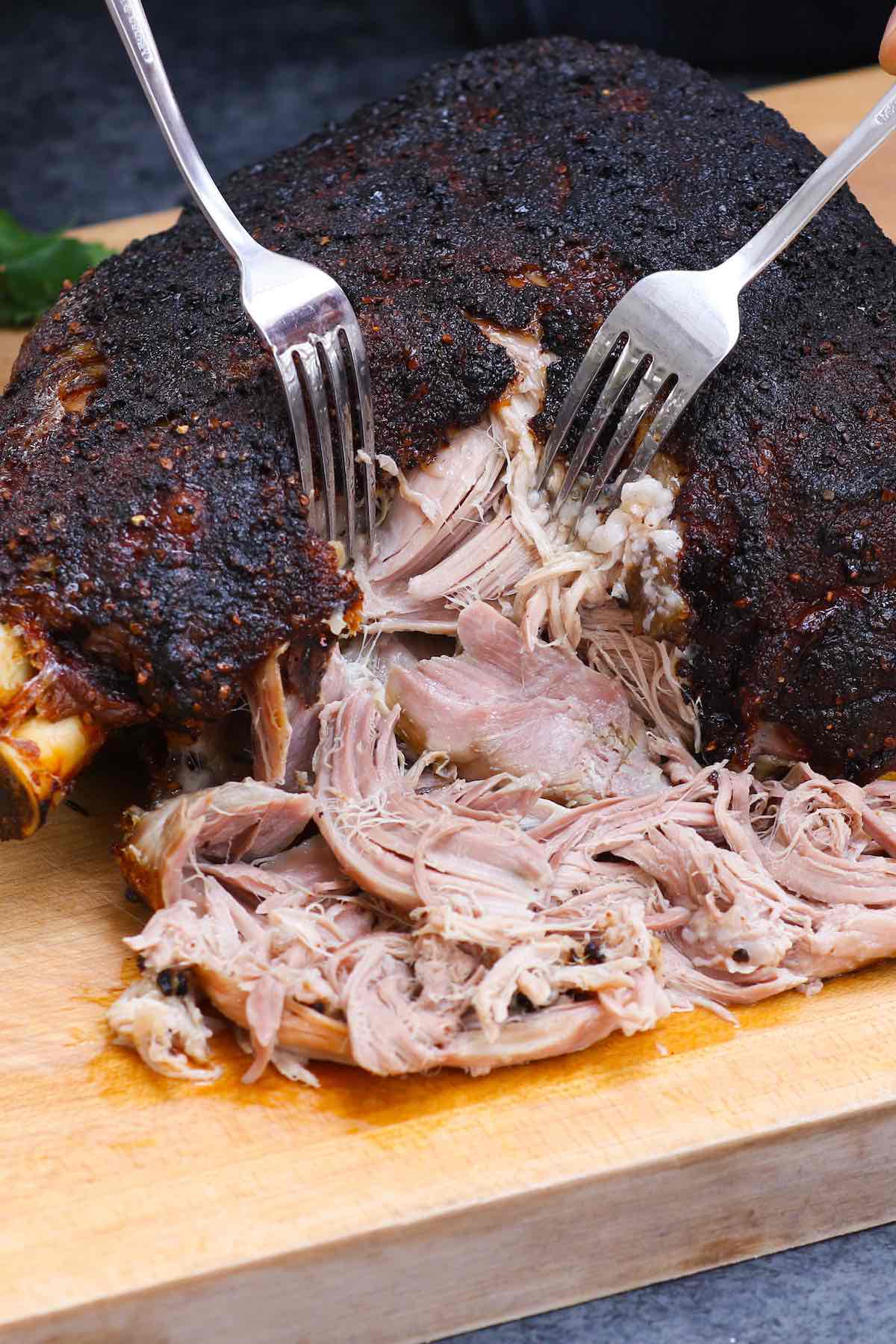 Shredding tender pork shoulder meat using two forks