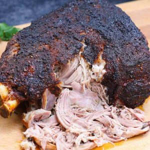 Smoked pork shoulder with with dark smokey crust and pulled meat