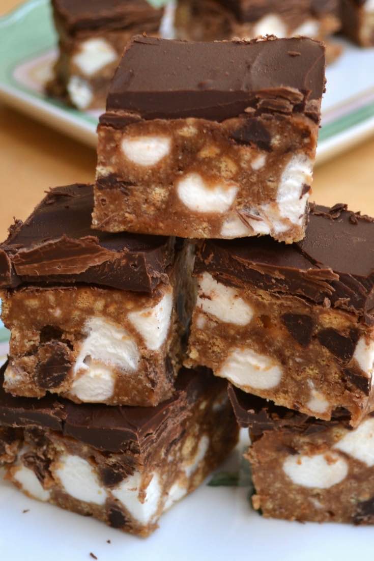 A stack of peanut butter s'mores brownies on a serving plate