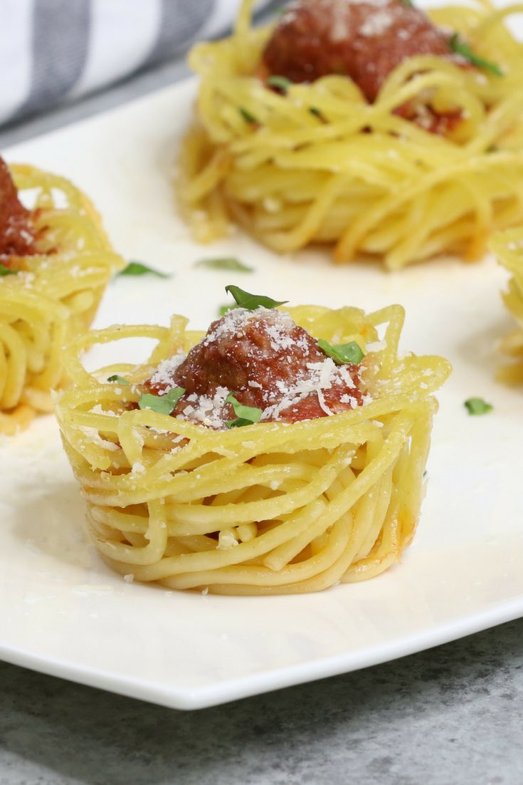 Baked Spaghetti and Meatball Cups on a serving platter for a delicious appetizer that's a great leftover spaghetti recipe!