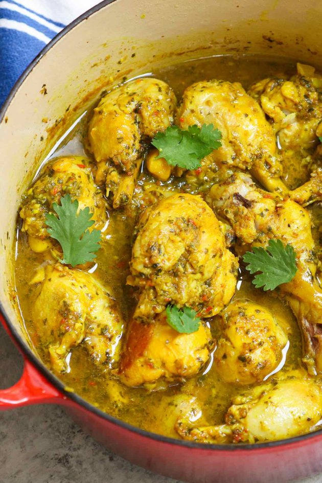 Trinidad curry chicken in a pot garnished with cilantro