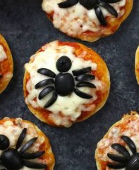 These Mini Spider Pizzas are the perfect snack for some spooky fun at your Halloween party