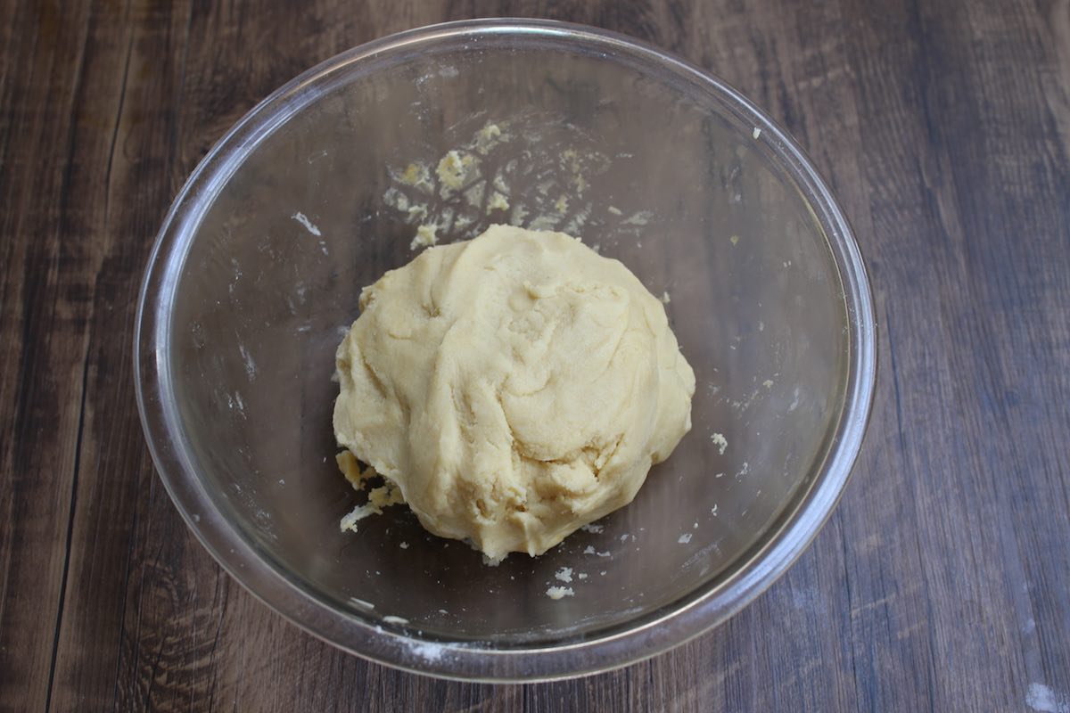 Close-up of the sugar cookie dough in a clear bowl.