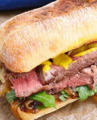 Steak Sandwich is a hearty and flavorful sandwich loaded with tender and thinly-sliced steak, green vegetables, caramelized onions and mustard, along with the delicious toasted buns.