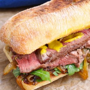 Steak Sandwich is a hearty and flavorful sandwich loaded with tender and thinly-sliced steak, green vegetables, caramelized onions and mustard, along with the delicious toasted buns.