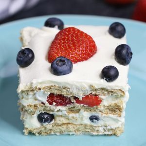 Strawberry Icebox Cake serving on a plate showing layers of pudding, graham crackers and fresh strawberries for a delicious no bake dessert