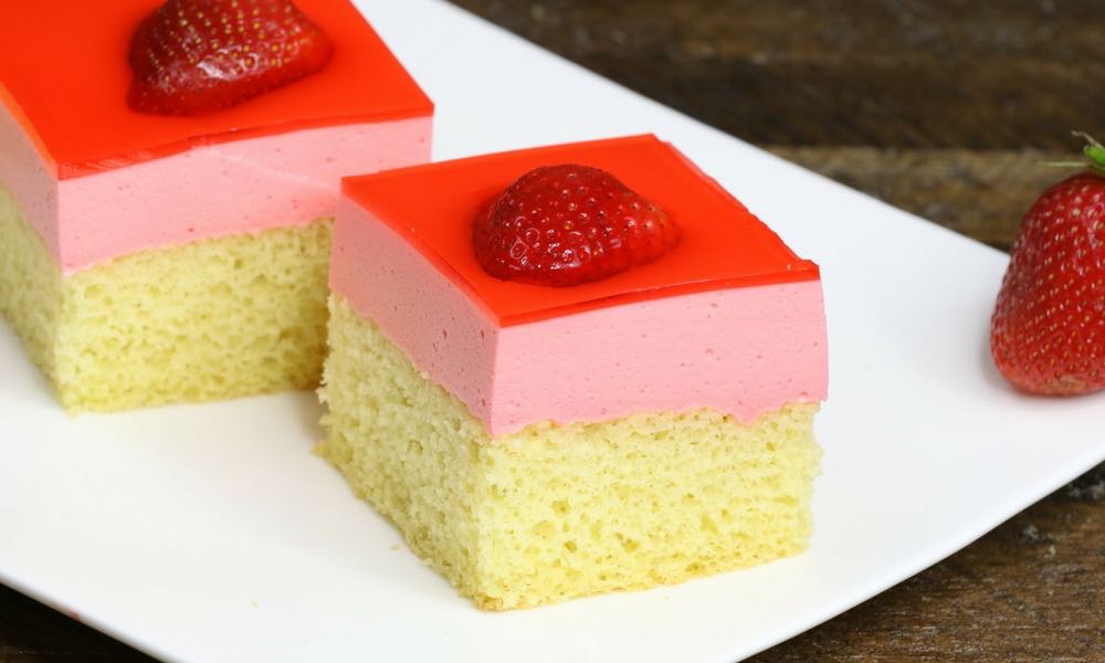 Fragment Of Layered Cake With Layers Of Sponge Cake, Milk Jelly And Berry  Jelly And Frozen Berries On A Glass Cake Serving Dish Stock Photo, Picture  and Royalty Free Image. Image 66064672.