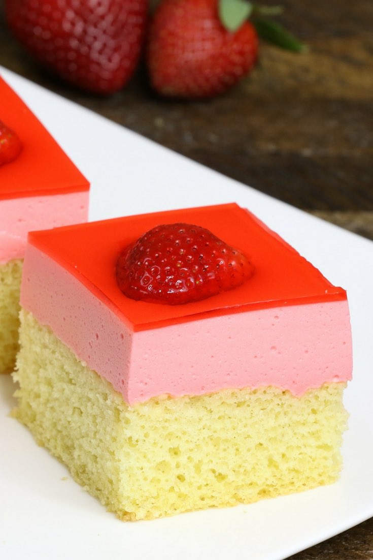Strawberry jello cake is a delicious dessert. All you need is a few simple ingredients: yellow cake, strawberry jello, whipped topping and strawberries. An easy recipe that makes an incredible dessert for parties, birthday parties, Mother’s Day and Easter. Video recipe. | Tipbuzz.com 