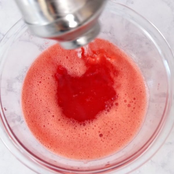 This is a photo making the strawberry jello mix in a bowl