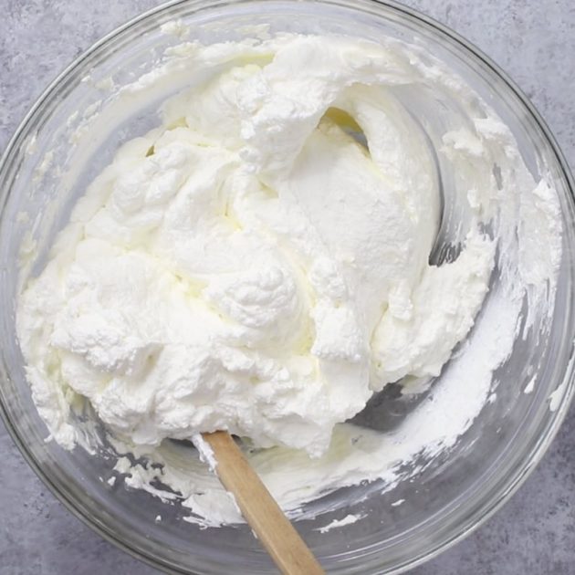 Mixing the cream cheese layer in a mixing bowl for Strawberry Pretzel Salad