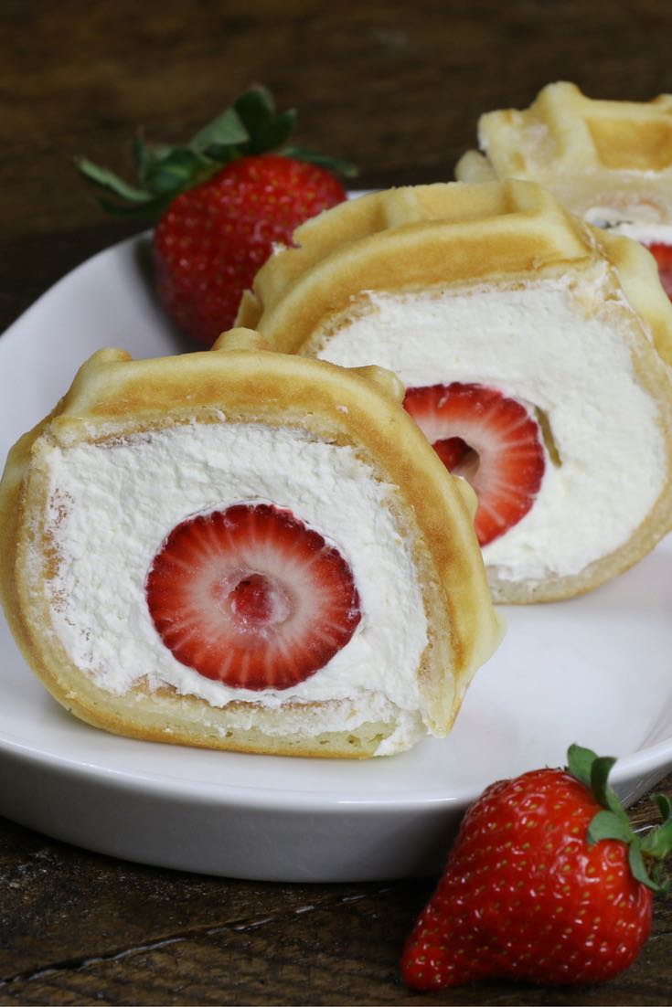 Strawberry Waffle Cake Roll - a quick and easy breakfast, snack or dessert made with waffle mix or frozen waffle, fresh strawberries, and whipped cream. Soft waffle topped with whipped cream, and strawberries. It melts in your mouth! So good and so beautiful! No bake dessert, vegetarian! | tipbuzz.com