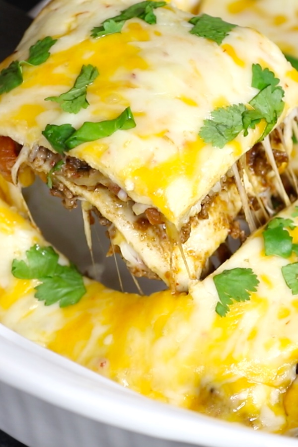 Freshly baked cheesy taco casserole in a white baking dish.