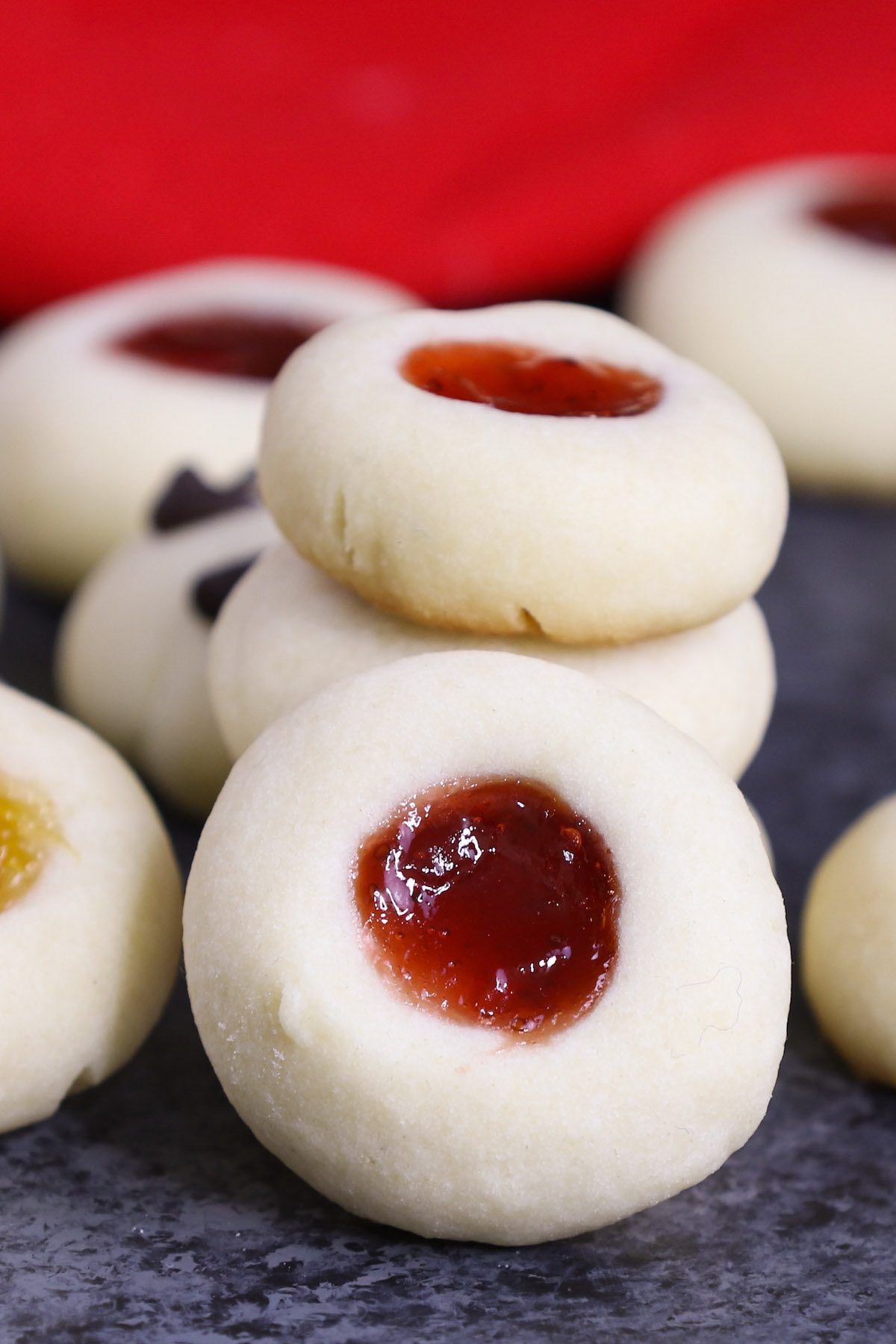 Thumbprint Cookies combine soft, buttery shortbread cookies with your favorite fillings for the perfect Christmas treat! The dough is made with just 5 simple ingredients, and then rolled into individual balls. Use your thumb to make an imprint before filling with your favorite jam, chocolate or other delicious fillings!