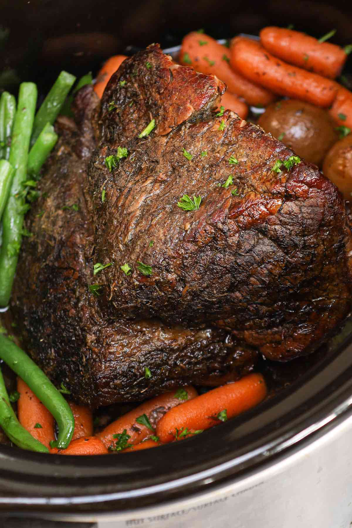 London broil with carrots, potatoes and green beans in the crock pot