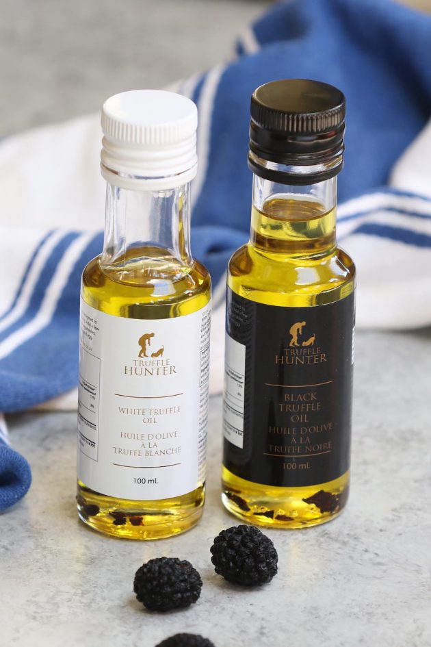 Black truffle oil and white truffle oil on the counter.